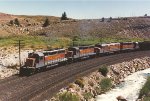 Loaded coal train climbs upgrade